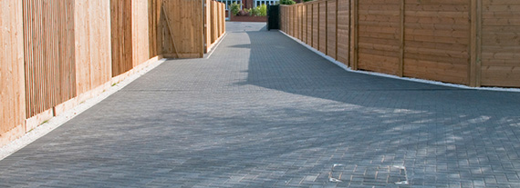 paved path between wooden fences with clear sky overhead ideal for outdoor exploration and walking 4 outdoor activities