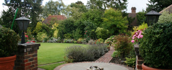 outline of several houses with a tree representing a peaceful residential neighborhood ideal for settlement gardening and family living