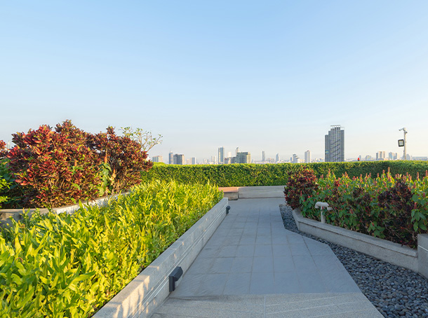 a beautiful garden scene featuring a small black table with two chairs surrounded by colorful flowers and lush greenery showcasing a serene outdoor space perfect for relaxation and seven stunning floral arrangements